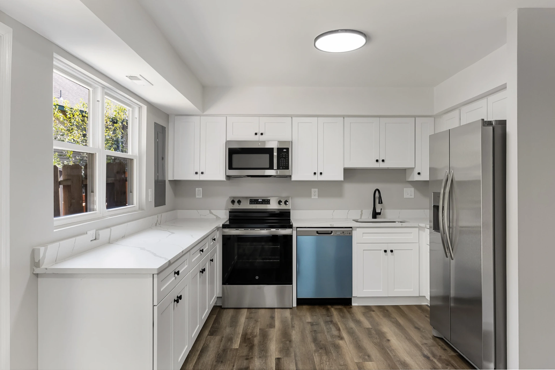 Custom white luxury kitchen with quartz waterfall island built by A1 Brothers in Bucks County, PA